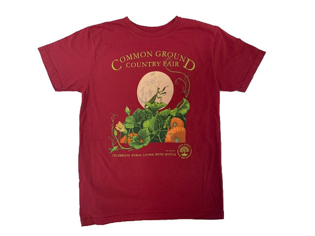 A red shirt with artwork in the center depicting a praying mantis standing on a green and orange pumpkin patch in front of a large full moon. Lime green text around art reads “Common Ground Country Fair” and  “Celebrate Rural Living with MOFGA”. A lime green MOFGA logo is in the bottom right corner. 