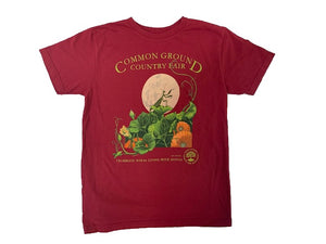 A navy shirt with artwork in the center depicting a praying mantis standing on a green and orange pumpkin patch in front of a large full moon. Lime green text around art reads “Common Ground Country Fair” and  “Celebrate Rural Living with MOFGA”. A lime green MOFGA logo is in the bottom right corner. 